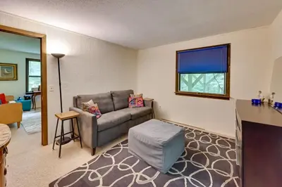 a living room with a couch and a table at Tolland Lake Escape Kayaks Deck and Nature Trails in Sandisfield