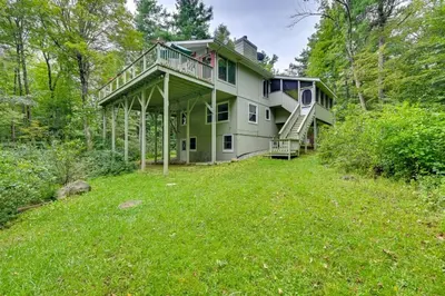 a house with a large yard in the woods at Tolland Lake Escape Kayaks Deck and Nature Trails in Sandisfield