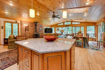 a kitchen and living room with a center island at Tolland Lake Escape Kayaks Deck and Nature Trails in Sandisfield