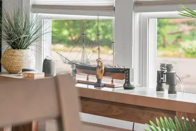 a model ship sitting on a window sill at Lake Me Home in East Hampton