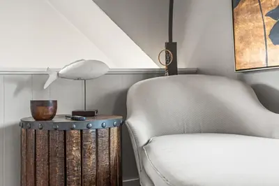 a living room with a couch and a chair at Lake Me Home in East Hampton