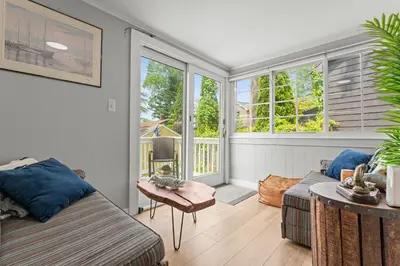 a living room with a couch and a table at Lake Me Home in East Hampton