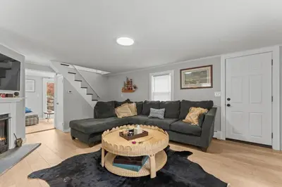 a living room with a couch and a table at Lake Me Home in East Hampton