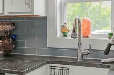 a kitchen counter with a sink and a window at Lake Me Home in East Hampton