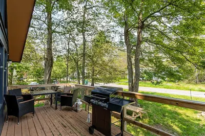 a deck with a piano and a table and chairs at Blue Diamond Hot Tub Fire Pit 3 BDR in Tobyhanna