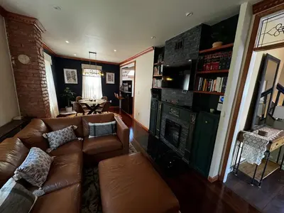 a living room with a couch and a fireplace at Morristown Charm in Morristown