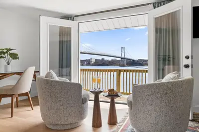 a living room with a view of a bridge at Hudson Escape W Hot Tub Bridge View in Highland