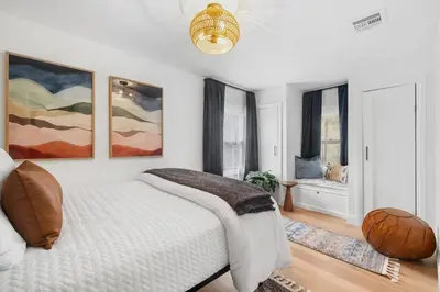 a bedroom with a bed and two paintings on the wall at Hudson Escape W Hot Tub Bridge View in Highland