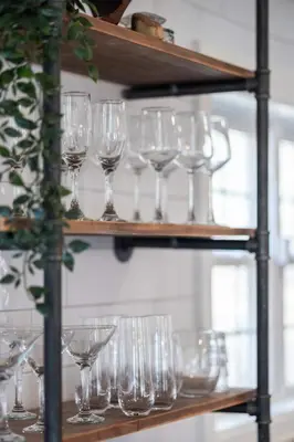 a bunch of wine glasses on a shelf at Hudson Escape W Hot Tub Bridge View in Highland