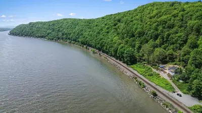 an aerial view of a river with trees and a beach at Hudson Escape W Hot Tub Bridge View in Highland