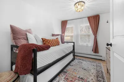 a bedroom with a bed with pillows and a window at Hudson Escape W Hot Tub Bridge View in Highland
