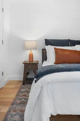 a bedroom with a bed and a table with a lamp at Hudson Escape W Hot Tub Bridge View in Highland