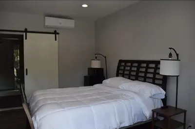 a bedroom with a white bed and a window at Tannersville Village Rooms on Saw Mill Creek in Tannersville