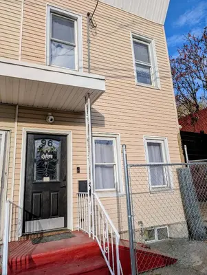 a house with a black door with a sign on it at Newly renovated luxury 3BR Condo! 30 mins to NYC in Jersey City