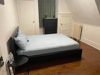 a small bedroom with a bed and a chair at The Peppermint in Mount Vernon