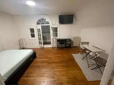 a bedroom with a bed and a table and chairs at The Peppermint in Mount Vernon