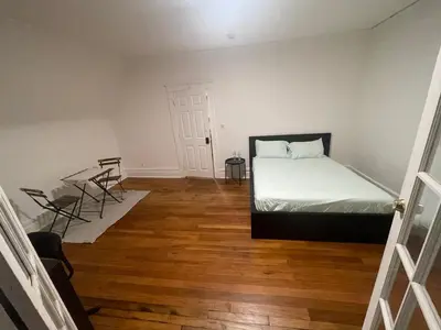 a bedroom with a bed and a table and chairs at The Peppermint in Mount Vernon