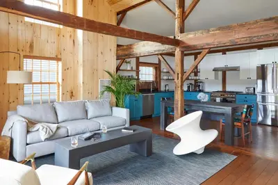 a living room with a couch and a table at The Kent Collection - The Garden Cottages in Kent