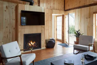 a living room with a fireplace and a tv at The Kent Collection - The Garden Cottages in Kent