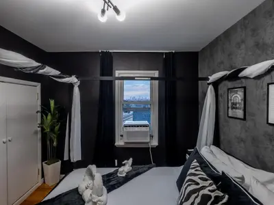 a bedroom with a bed with two stuffed animals on it at Elegant NYC View Stay Park Free 6 beds Sleep 8 in Kearny
