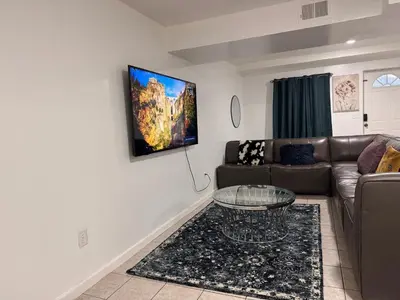 a living room with a couch and a table at Large 2Kings 2 bedroom 2 bath by EWR NYC Downtown Newark in Newark
