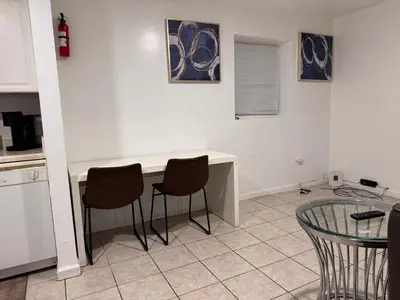 a kitchen with a table and chairs in a room at Large 2Kings 2 bedroom 2 bath by EWR NYC Downtown Newark in Newark