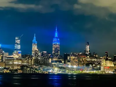 a city skyline at night with blue lights at Renovated private urban flat - 20 min to Manhattan NYC in Jersey City