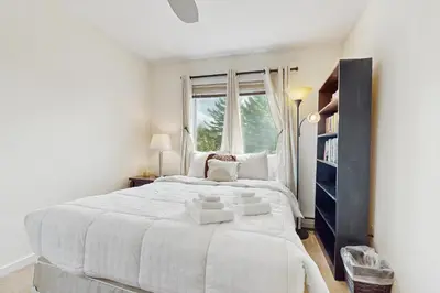 a white bedroom with a large bed and a window at 17A Mountain Village #241 in Dover