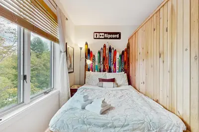 a bedroom with a bed with skis on the wall at 17A Mountain Village #241 in Dover