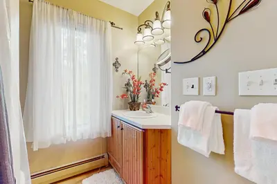 a bathroom with a sink and a mirror at 17A Mountain Village #241 in Dover