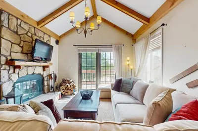 a living room with a couch and a fireplace at 17A Mountain Village #241 in Dover