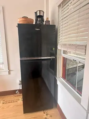 a black refrigerator in a kitchen next to a window at Cute Cozy Cottage Glenford New York in Glenford