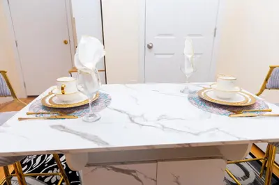 a white marble table with two cups and glasses on it at Luxury Vibes ,Cozy Location in East Orange