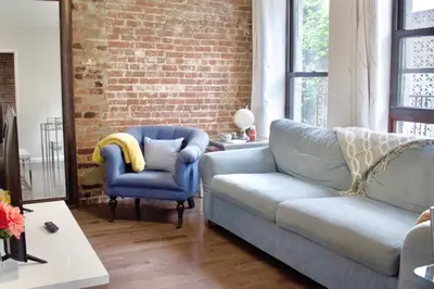 a living room with a couch and two chairs at Stay In Times Square! 2-Bedroom Apartments in New York