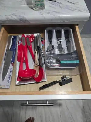 a drawer with scissors and other kitchen utensils at A newly built detached studio apartment with queen size bed in Irvington