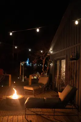a fire pit on a patio at night at Mountain Cabin 20mins to Hunter Mt, hiking trails-3bds & 3baths in Catskill