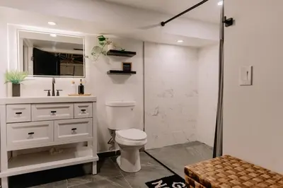 a bathroom with a toilet and a sink and a shower at Mountain Cabin 20mins to Hunter Mt, hiking trails-3bds & 3baths in Catskill