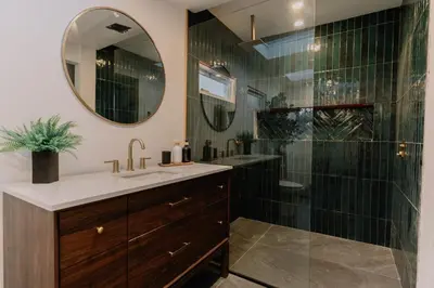 a bathroom with a shower and a sink and a mirror at Mountain Cabin 20mins to Hunter Mt, hiking trails-3bds & 3baths in Catskill