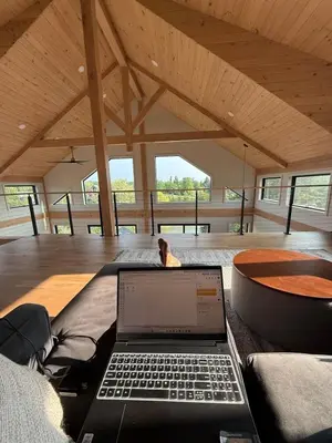 a laptop computer sitting on a couch in a room at Gray Owl Lodge- A Serene Lakefront Retreat on Sleepy Hollow Lake near Hudson NY in Athens