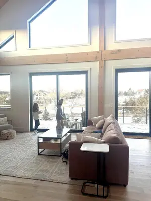 a living room with a couch and a table at Gray Owl Lodge- A Serene Lakefront Retreat on Sleepy Hollow Lake near Hudson NY in Athens