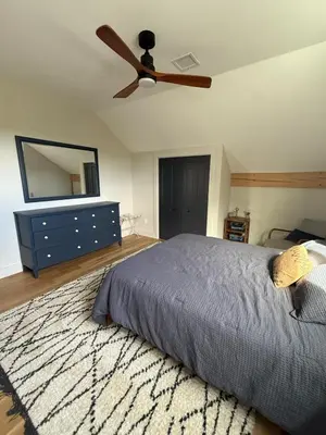 a bedroom with a bed and a ceiling fan at Gray Owl Lodge- A Serene Lakefront Retreat on Sleepy Hollow Lake near Hudson NY in Athens