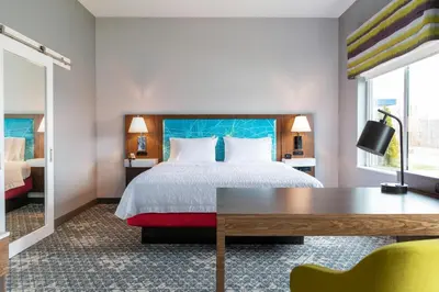 a hotel room with a bed and a desk at Hampton Inn & Suites By Hilton North Haven in North Haven