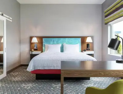 a hotel room with a bed and a desk at Hampton Inn & Suites By Hilton North Haven in North Haven