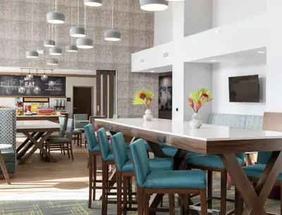 a dining room with a large table and chairs at Hampton Inn & Suites By Hilton North Haven in North Haven
