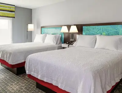 a hotel room with two beds with white sheets at Hampton Inn & Suites By Hilton North Haven in North Haven