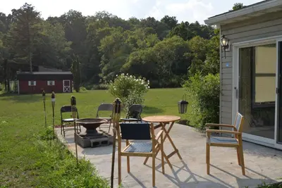 a patio with chairs and a table and a grill at Luxurious 3 Bedroom, 3 Bathroom, Entire Home in Catskill in Catskill