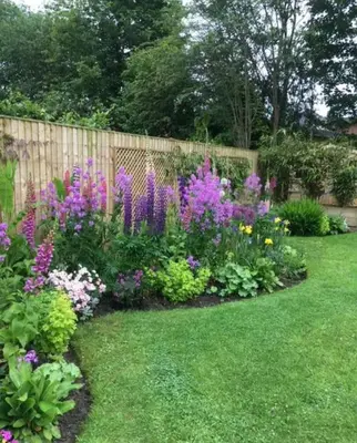 a garden of flowers in front of a fence at Beautiful Private Room Near Stony Brook University in Stony Brook