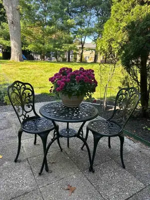 two chairs and a table with a vase of flowers at Beautiful Private Room Near Stony Brook University in Stony Brook