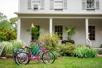 two bikes parked in the grass in front of a house at ButtonBall Inn in South Egremont