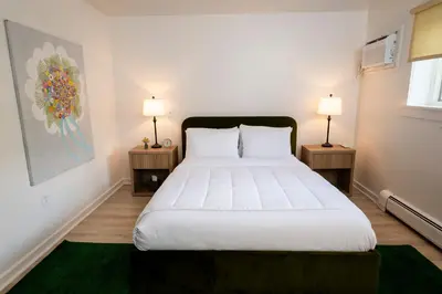 a bedroom with a large bed with two night stands at ButtonBall Inn in South Egremont